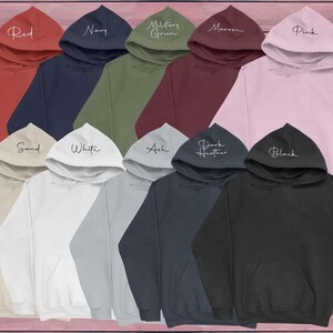 May include: A variety of hooded sweatshirts in different colors, including red, navy, military green, maroon, pink, sand, white, ash, dark heather, and black. Each sweatshirt has a different color and a white text label on the front.