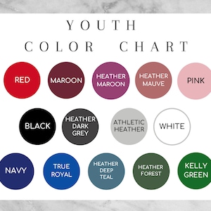 May include: Color chart for youth clothing with 12 color swatches. The colors are red, maroon, heather maroon, heather mauve, pink, black, heather dark grey, athletic heather, white, navy, true royal, heather deep teal, heather forest, and kelly green.