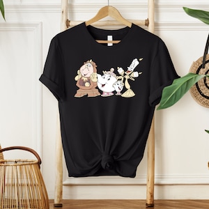 May include: Black t-shirt with a graphic print of the characters from Beauty and the Beast: Cogsworth, Mrs. Potts, and Lumiere.