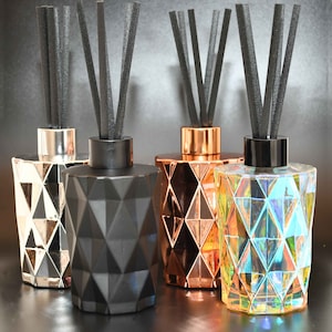 A diamond cut, glass, reed diffuser, gift boxed, 170ml, highly fragranced, premium oils, in a pearlescent  glass bottle with Black Reeds