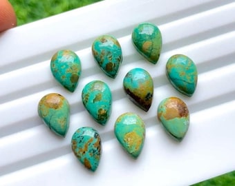 May include: A collection of ten teardrop-shaped turquoise gemstones. The stones display a mix of vibrant teal and brown hues, with natural veining patterns. They are arranged on a white surface, showcasing their polished appearance.