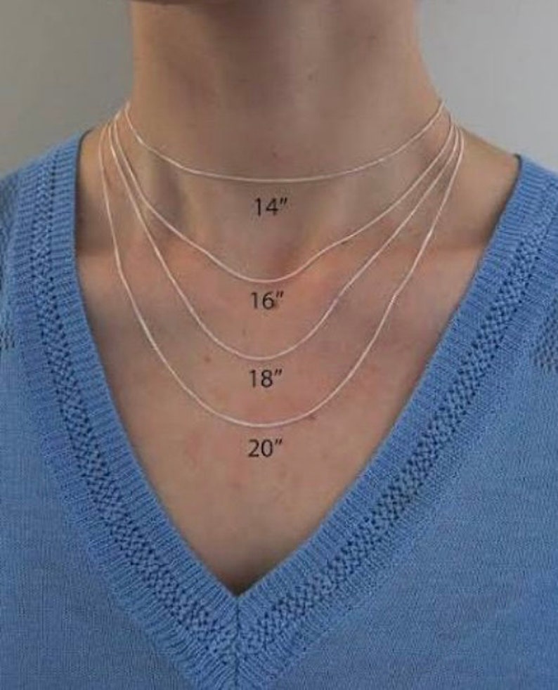 May include: A model wears four silver chains of different lengths, labeled 14", 16", 18", and 20".