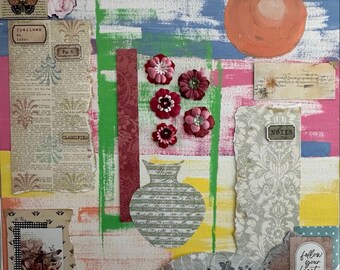 May include: A mixed media collage with a variety of textures and colors. The artwork features paper ephemera, fabric flowers, and a painted orange circle. Text includes "love", "specimen", "classified", "notes", and "follow your heart".