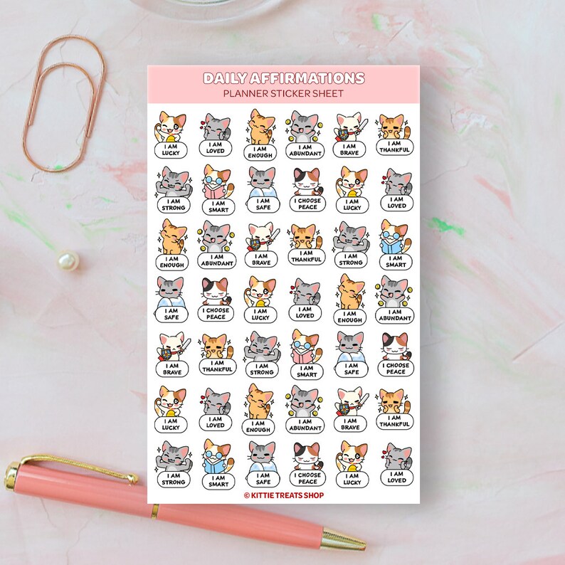 May include: A sheet of planner stickers featuring cute cartoon cats with positive affirmations. The stickers include phrases like "I am strong", "I am loved", and "I choose peace".