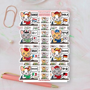 May include: A sticker sheet featuring cartoon cats wearing hats and reading books, each paired with a national flag and a speech bubble containing a greeting in a different language, including GOED, HOLA, OUI, DANKE, GRAZIE, and Chinese characters.