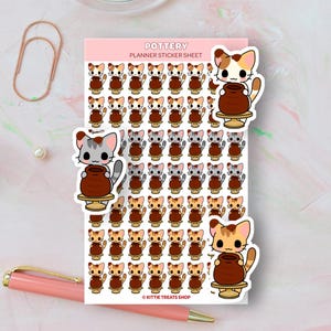 May include: A sheet of planner stickers featuring adorable cartoon cats making pottery. The stickers are in various colors, including brown, gray, and white. The sheet includes the text "Pottery Planner Sticker Sheet" and "Kittie Treats Shop".