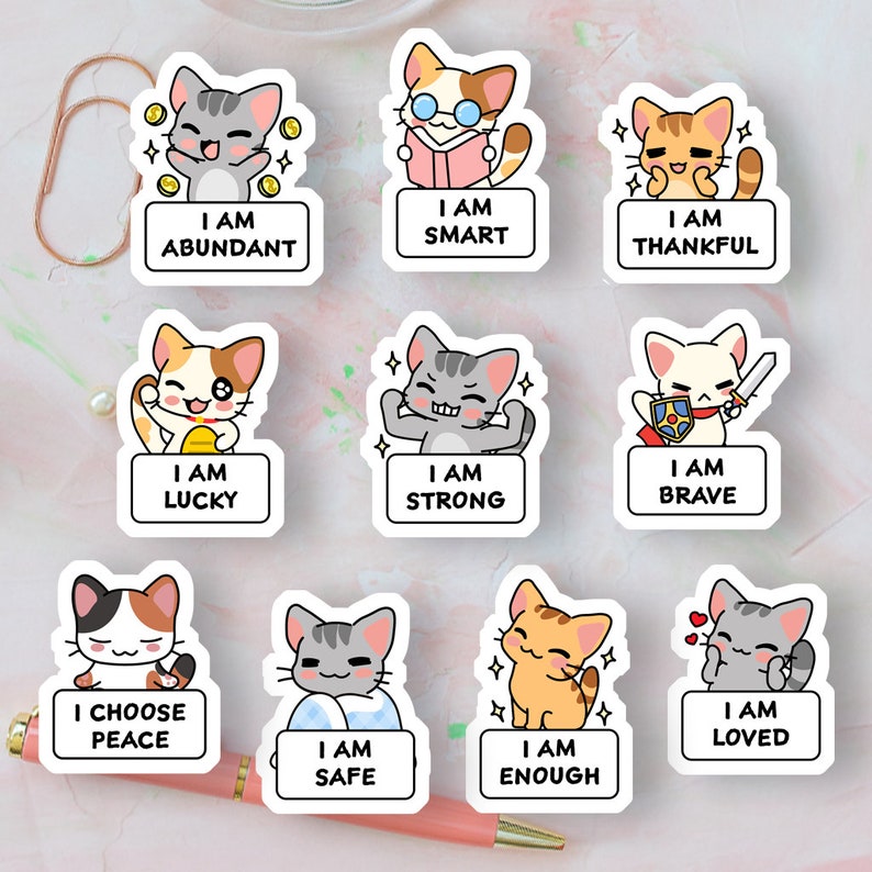 May include: Nine colorful stickers featuring cartoon cats with positive affirmations. Each sticker has a white border and features a different cat with a different affirmation. The affirmations include "I am abundant", "I am smart", "I am thankful", "I am lucky", "I am strong", "I am brave", "I choose peace", "I am safe", "I am enough", and "I am loved".