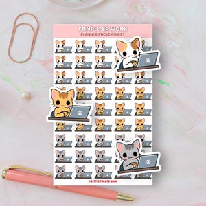 May include: A planner sticker sheet with the text "COMPUTER WORK" and illustrations of cats working on laptops. The stickers feature cats in various colors, including orange, gray, and calico, holding coffee cups. A pink pen and paperclip are also in the image.