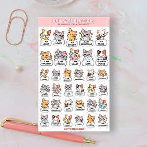 May include: A sheet of planner stickers featuring cute cartoon cats with positive affirmations. The stickers include phrases like "I am lucky", "I am loved", "I am enough", "I am abundant", "I am brave", "I am thankful", "I am strong", "I am smart", "I am safe", "I choose peace".