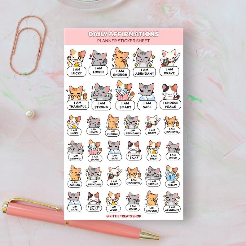 May include: A sheet of planner stickers featuring cute cartoon cats with positive affirmations. The stickers include phrases like "I am lucky", "I am loved", "I am enough", "I am abundant", "I am brave", "I am thankful", "I am strong", "I am smart", "I am safe", "I choose peace".