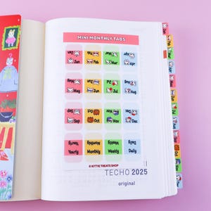 May include: A set of colorful monthly tabs for a planner or journal. Each tab features a cute cartoon animal and the name of the month. The tabs are labeled "Mini Monthly Tabs" and are part of the "TECHO 2025" collection.