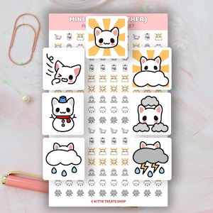 May include: A sheet of planner stickers featuring various weather-themed cat illustrations. The stickers include images of cats with sunburst backgrounds, rain clouds, snowmen, and lightning. The text "KITTIE TREATS SHOP" is at the bottom.