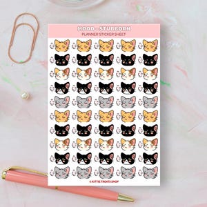 Pu&ograve; includere: Un foglio di adesivi per planner con 36 adorabili gatti dei cartoni animati con diverse espressioni. I gatti sono di vari colori, tra cui arancione, nero, grigio e bianco. Il testo "MOOD - STUBBORN PLANNER STICKER SHEET" &egrave; in cima al foglio. Il testo "&copy; KITTIE TREATS SHOP" &egrave; in fondo al foglio.