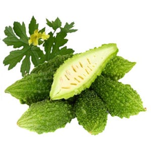 May include: A close-up of several green bitter melon, also known as bitter gourd, with one cut open to reveal the white flesh and seeds. The fruit is surrounded by green leaves.