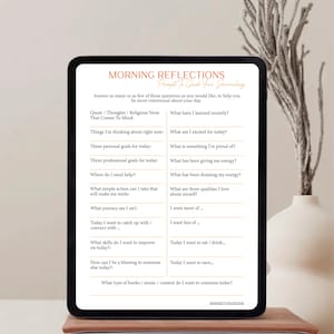 May include: A digital tablet displaying a printable worksheet with prompts for morning reflection journaling. The worksheet includes questions such as "What have I learned recently?" and "What am I excited for today?"