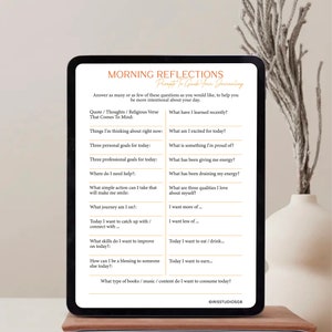 May include: A digital tablet displaying a printable worksheet with prompts for morning reflection journaling. The worksheet includes questions such as "What have I learned recently?" and "What am I excited for today?"