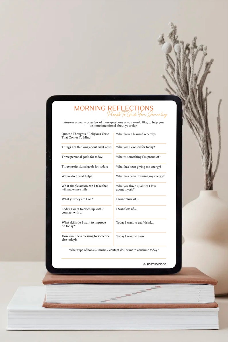 May include: A digital tablet displaying a printable worksheet with prompts for morning reflection journaling. The worksheet includes questions such as "What have I learned recently?" and "What am I excited for today?"