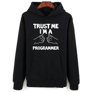 May include: Black hoodie with white text that reads "Trust me I'm a programmer" with two thumbs up symbols.