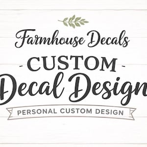 May include: A graphic design featuring the text Farmhouse Decals, CUSTOM, Decal Design, and PERSONAL CUSTOM DESIGN in black lettering. A small green leaf icon is positioned above the text. The entire design is set against a white wood background.