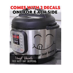 May include: A stainless steel Instant Pot pressure cooker featuring a black vinyl decal of a winking, tongue-out smiley face on the front. The decal includes the text 'Your text here' below the face. The text 'COMES WITH 2 DECALS ONE FOR EACH SIDE' appears above.