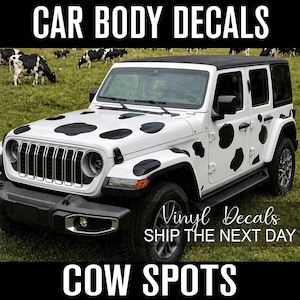 May include: White Jeep Wrangler with black cow spot decals. The text "CAR BODY DECALS" and "COW SPOTS" are displayed in black. The text "Vinyl Decals" and "SHIP THE NEXT DAY" are also displayed.