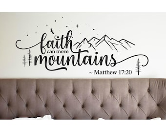 May include: A black wall decal featuring the text faith can move mountains and Matthew 17:20. The design includes a mountain range silhouette, pine trees, a bird, and small stars, all rendered in a clean, script and sans-serif typography.