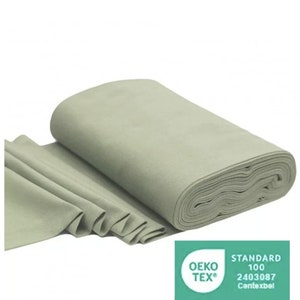 May include: A roll of light green fabric with the Oeko-Tex Standard 100 certification label. The label has the text "STANDARD 100" and the number "2403087" with the words "Contexbel" underneath.
