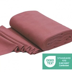 May include: A roll of deep rose colored fabric with the Oeko-Tex Standard 100 certification label. The label states "Standard 100 2403087  Contexbel".