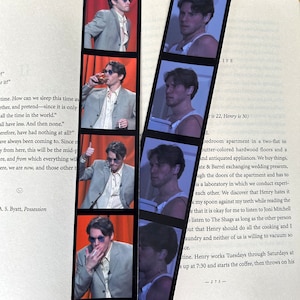 May include: A set of six bookmarks featuring a man with dark hair and a white tank top. The bookmarks are black with white borders. The text "LIFE" is visible on the top bookmark.