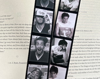 May include: A set of black and white photo bookmarks featuring a man with different expressions. The bookmarks are printed with a white border and the text "D Life" and "Clare is 22, Henry is 30".