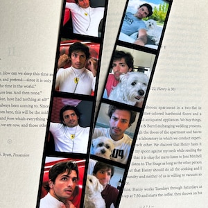 May include: A photo strip of a man with a white dog. The man is wearing a variety of shirts, including a white shirt with a red Ferrari logo, a black shirt, and a grey shirt. The dog is a small white dog with floppy ears. The photo strip is printed on a black background.