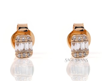 May include: A pair of gold stud earrings with a rectangular design featuring a row of baguette-shaped diamonds.