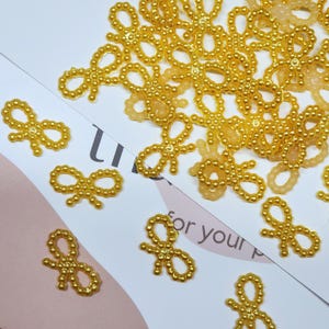 Tiny Yellow Beaded Bow for Summer Craft Projects, Bright Scrapbook Embellishment, Joyful Handmade Card Accent, Mini Plastic Bow for Jewelry, Journals, and Birthday Gift Wrapping, Cheerful DIY Supply