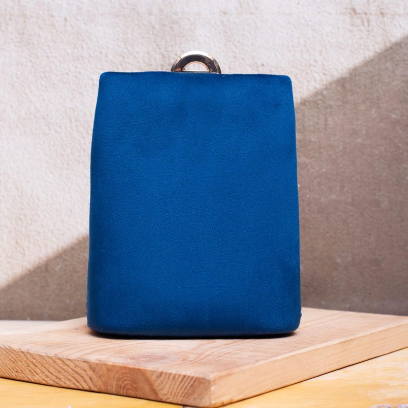 Compact navy blue clutch with sleek gold accents, ideal for weddings, proms, or date nights.