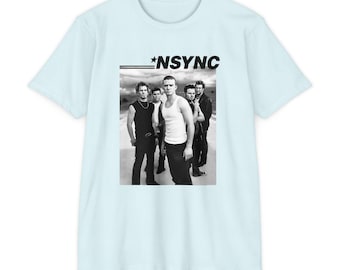 May include: A light blue t-shirt featuring a black and white image of the band *NSYNC. The image shows the five band members standing together. The band's name, *NSYNC, is printed in black above the image.