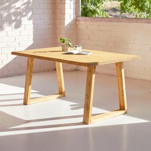 Blenom Guanaca Wooden Table, rustic dining table with irregular edges, made of natural wood and trapezoid wooden legs. Rectangular table.
