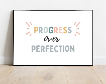 May include: A motivational poster with the text "PROGRESS over PERFECTION" in colorful letters with a sunburst design on either side of the text.