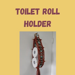 May include: A handmade macrame toilet roll holder in shades of rust and green, holding two rolls of toilet paper. The text "TOILET ROLL HOLDER" is displayed at the top, with "Easy to follow step-by-step picture guide" below. The Etsy shop name is also visible.