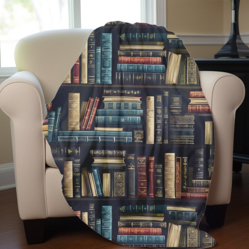 May include: A throw blanket with a repeating pattern of a bookshelf filled with vintage books. The books are in various colors, including red, blue, green, and gold. The bookshelf is dark brown and the background is black.