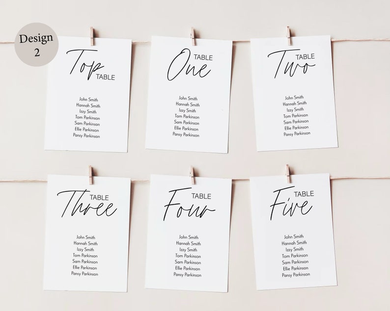 Peut inclure: Cartes blanches avec calligraphie noire pour une r&eacute;ception de mariage. Les cartes sont &eacute;tiquet&eacute;es "Top Table", "Table One", "Table Two", "Table Three", "Table Four", et "Table Five". Chaque carte liste les noms des invit&eacute;s assign&eacute;s &agrave; cette table.