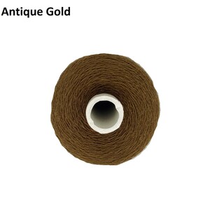 May include: A spool of brown thread labelled "Antique Gold".