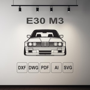 Pode incluir: Desenho a preto e branco de um carro E30 M3. O texto "E30 M3" está acima do carro. Abaixo do carro estão os ícones de tipo de arquivo: DXF, DWG, PDF, AI e SVG. A imagem está numa parede branca com iluminação de calha.