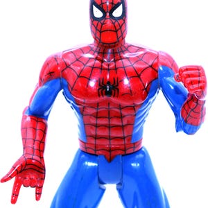 May include: A red and blue plastic action figure of Spider-Man. The figure has a detailed design with a red and black spider symbol on the chest.