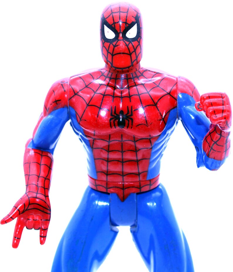 May include: A red and blue plastic action figure of Spider-Man. The figure has a detailed design with a red and black spider symbol on the chest.