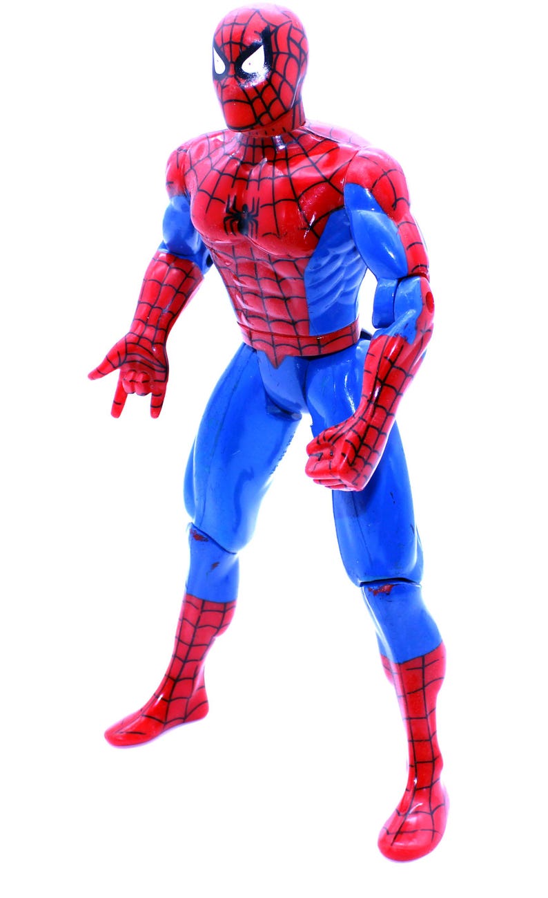 May include: A red and blue plastic action figure of Spider-Man. The figure has a web design on its suit and is posed in a fighting stance.