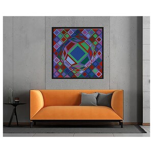 May include: An abstract geometric artwork in a black frame hangs above an orange sofa. The artwork features a central blue diamond shape surrounded by colorful diamond patterns in red, green, purple, and blue. A small black side table and gray pillows complete the scene.