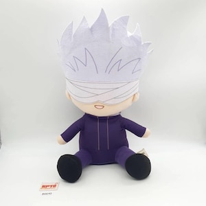 May include: Plush doll of a character with white hair and a blindfold. The doll is wearing a purple outfit with black shoes. The doll has a white headpiece and is sitting down. The doll is a collectible item.