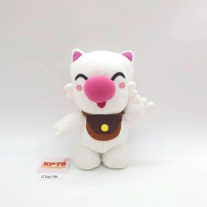May include: A white plush toy with a large pink nose, small pink ears, and a brown satchel. The toy has a smiling expression and outstretched arms. The tag reads "KPTD" and "C0678".