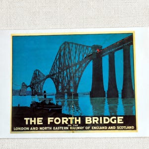 May include: A vintage-style poster featuring the Forth Bridge in deep blue tones. The text reads THE FORTH BRIDGE ON THE LONDON AND NORTH EASTERN RAILWAY OF ENGLAND AND SCOTLAND. A small boat is visible in the foreground below the large steel structure.