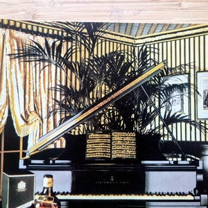 May include: An illustration of a grand piano with a black finish, open to reveal sheet music. A bottle of liquor and a box are in the foreground. The background features a room with gold curtains, striped wallpaper, and framed artwork.